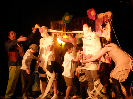 Helping some families wrap someone in toilet paper so they can meet a celebrity