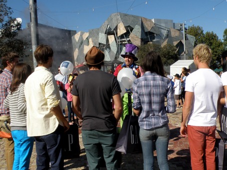 Matty Hatter with a crowd on on-lookers at Federation Square